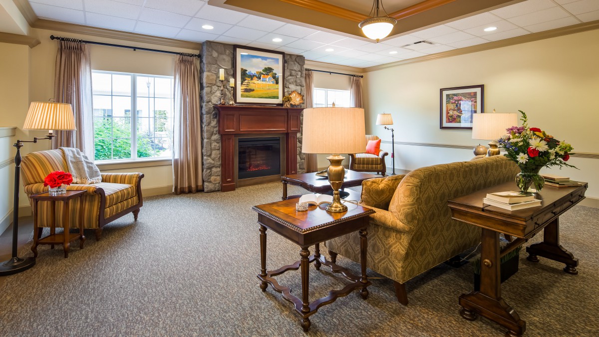 A cozy living room with comfortable furniture, a fireplace, and warm lighting.