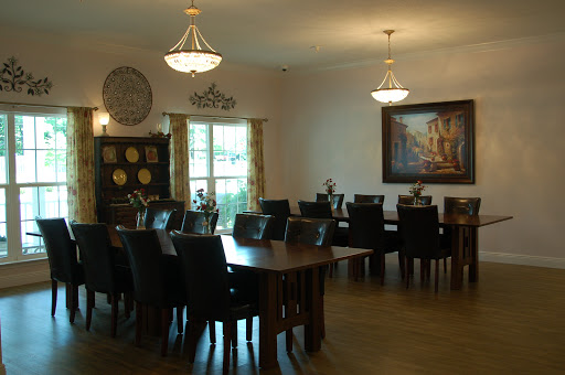 A spacious dining room featuring elegant furniture and ambient lighting.