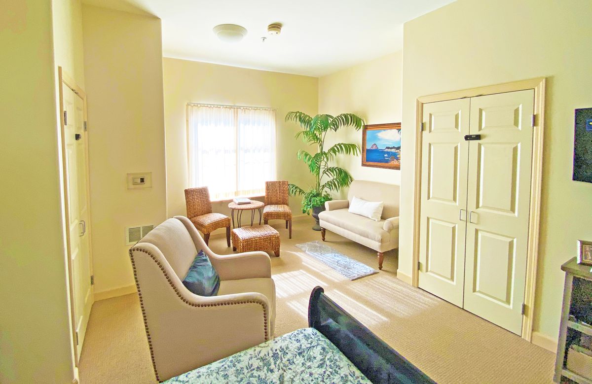 A cozy and well-lit living room with comfortable seating and tasteful decor.