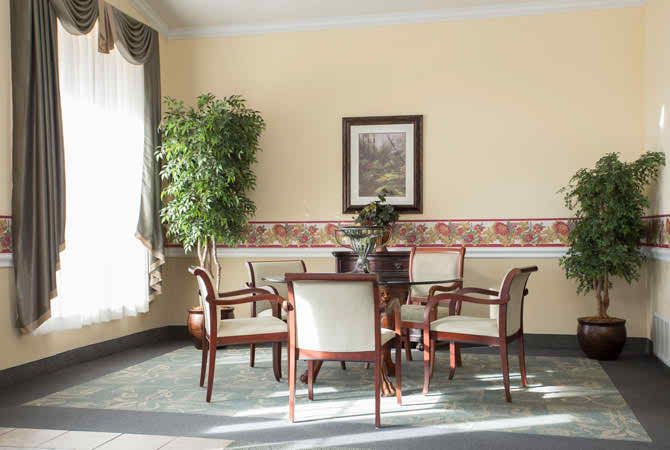 A well-lit dining area with a table, chairs, and decorative elements.