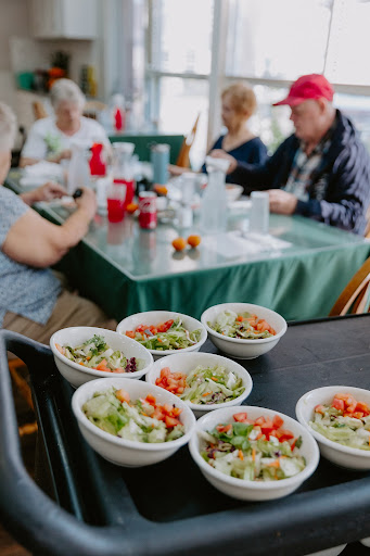 A vibrant spread of fresh salads served at a communal dining table.