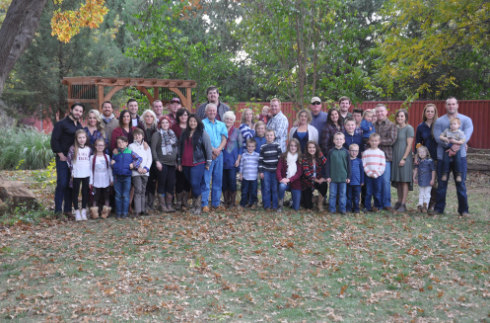 A joyful family gathering in a beautiful autumn setting.