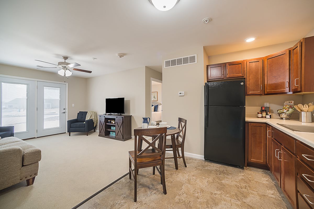 Open-concept apartment with a cozy living room, dining area, and kitchen.