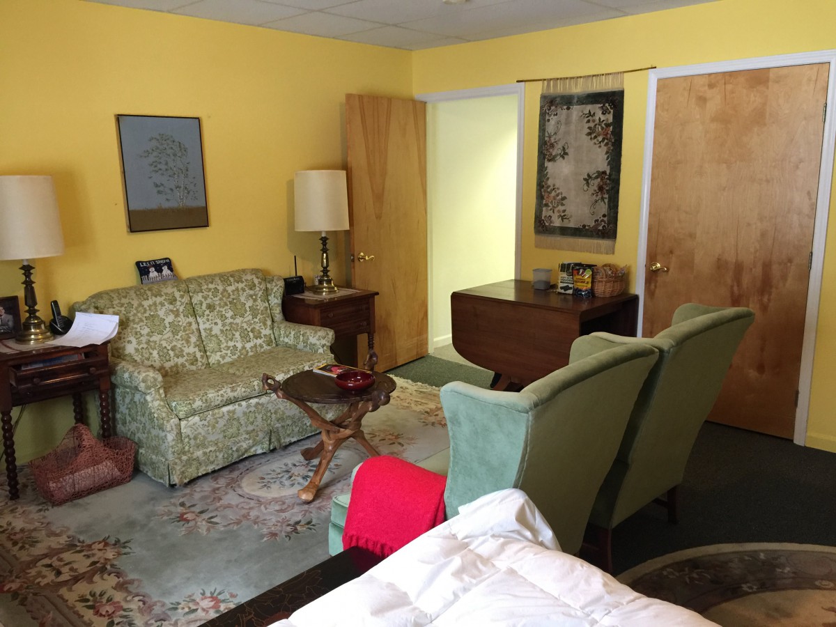 A cozy living room with vintage decor and retro-style furniture.