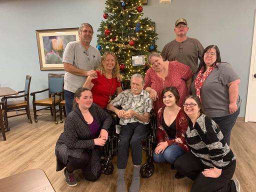 A joyful family gathering around the Christmas tree, celebrating together.
