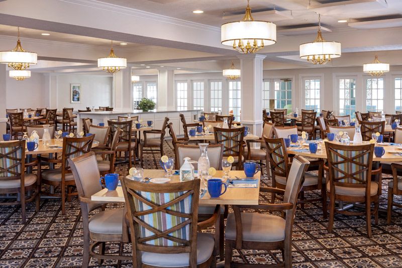An elegant and spacious dining room with neatly arranged tables and chairs.