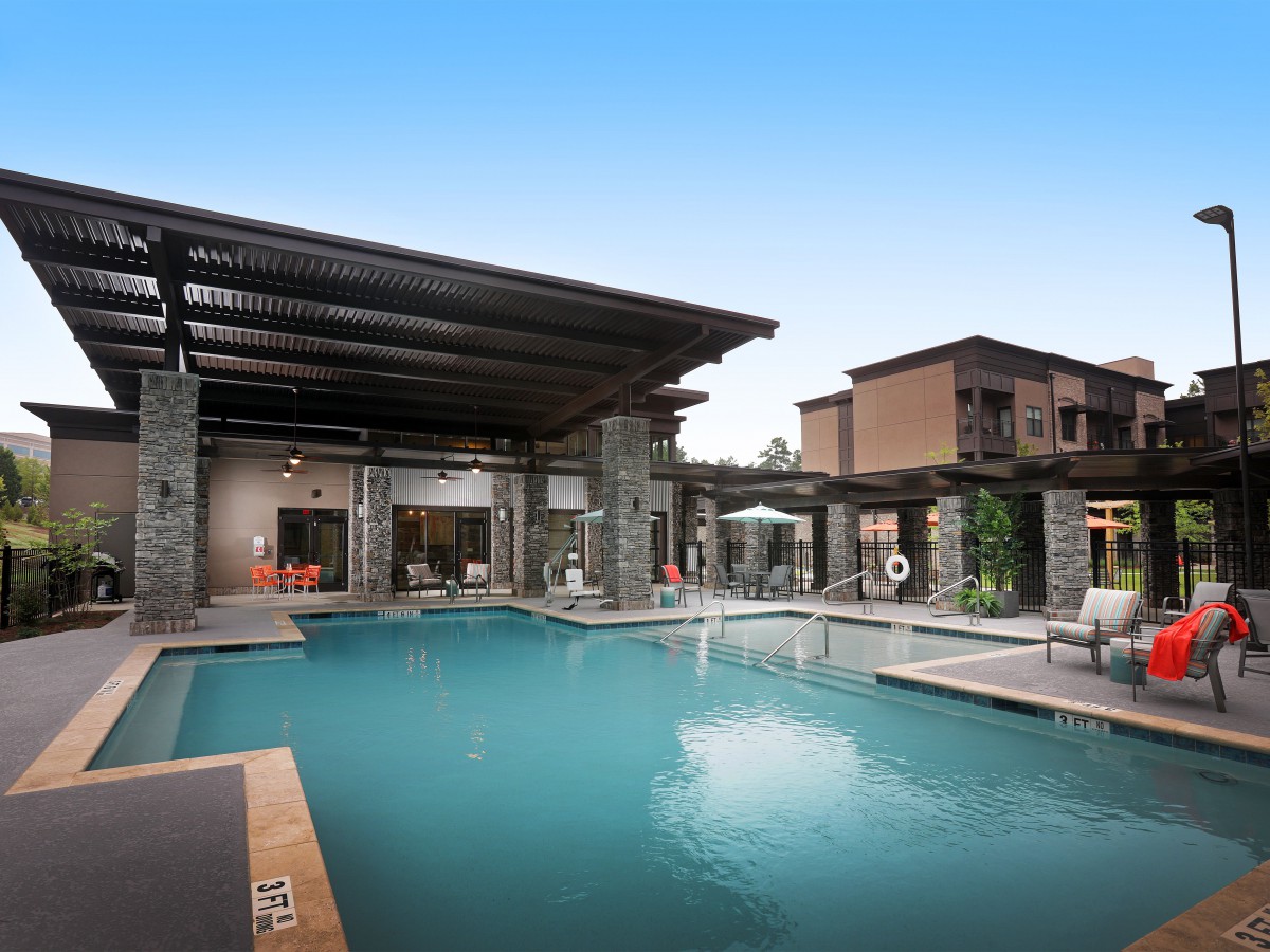 A modern residential property featuring a luxurious outdoor pool and patio area.
