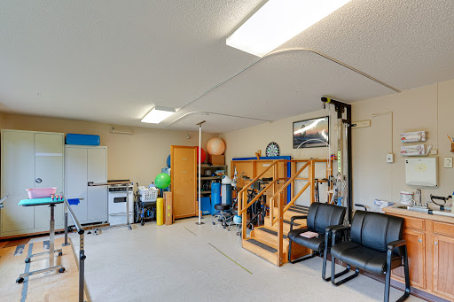 A well-organized garage space featuring storage solutions, exercise equipment, and seating.