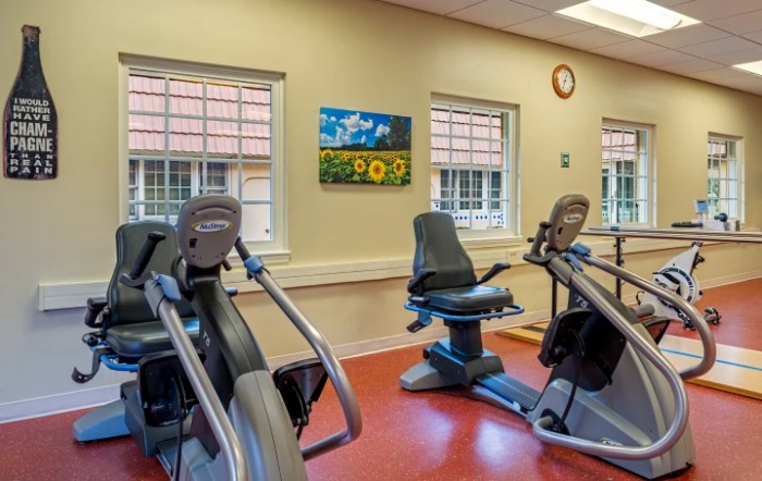 A fitness room featuring stationary bikes and cardio equipment.