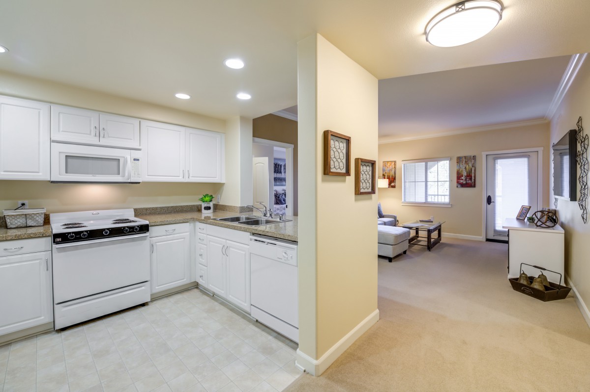 A cozy open layout apartment featuring a modern kitchen and a comfortable living room.