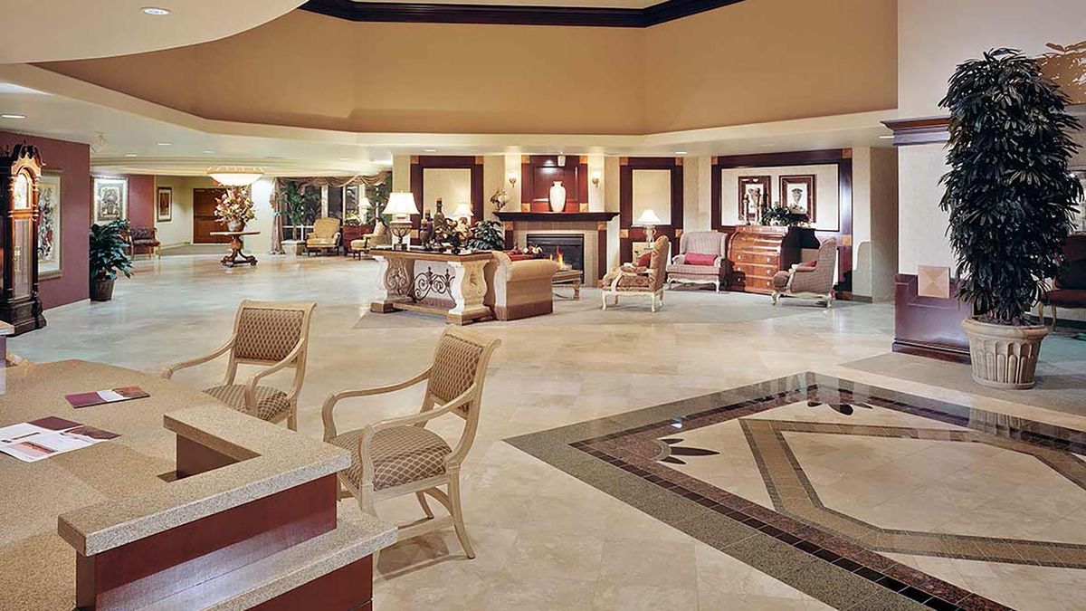 A luxurious hotel lobby featuring elegant furniture and ambient lighting.