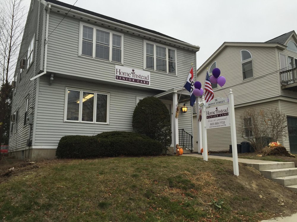 A house with a 'for sale' sign, decorated with balloons and an American flag.
