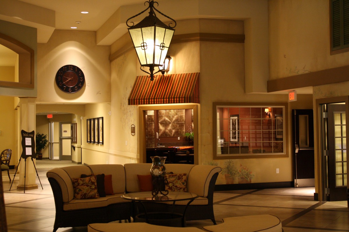 A warmly lit lobby with comfortable seating and elegant decor.