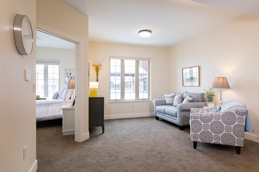 A cozy living room featuring a comfortable sofa and large windows that let in natural light.