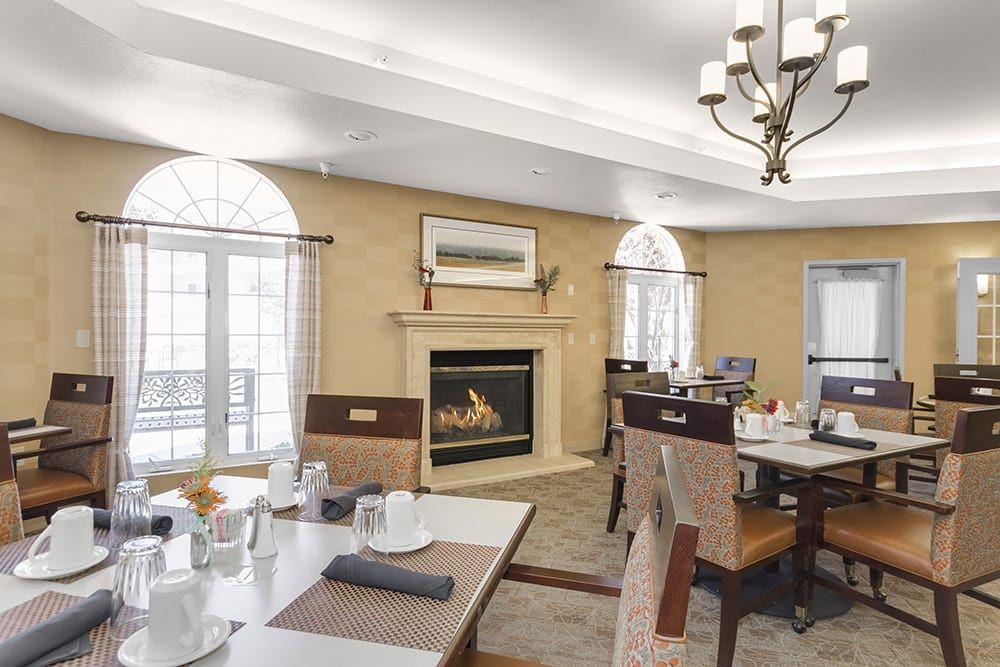 A cozy dining room featuring a fireplace and elegant seating arrangement.