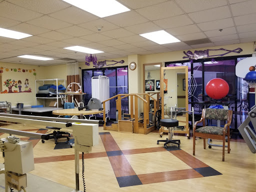 A well-equipped physical therapy room featuring various exercise and rehabilitation tools.