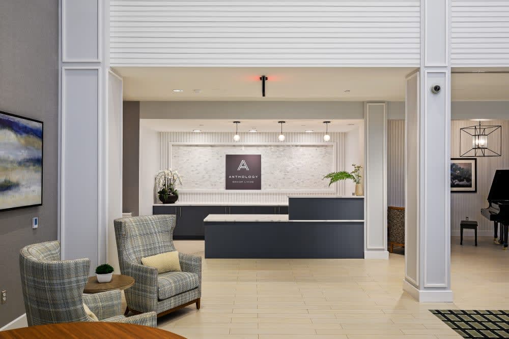 A modern reception area with comfortable seating and a sleek desk.