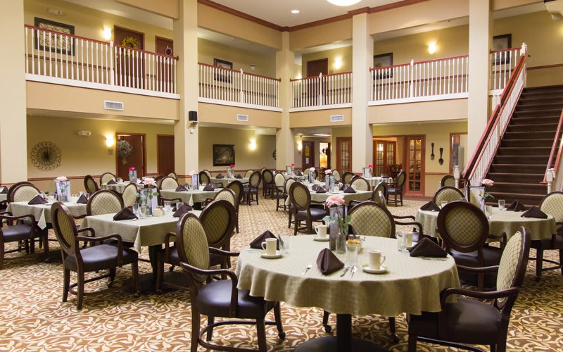 An elegant indoor dining area with neatly arranged tables and chairs.