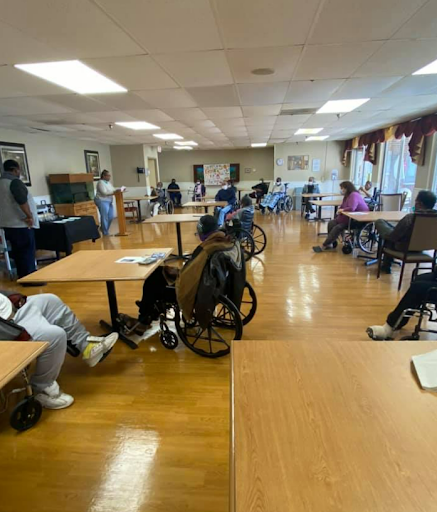 Elderly individuals engaging in activities at a community center.