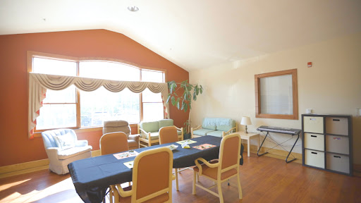 A well-lit meeting room with a long table and comfortable chairs, perfect for discussions and collaborations.
