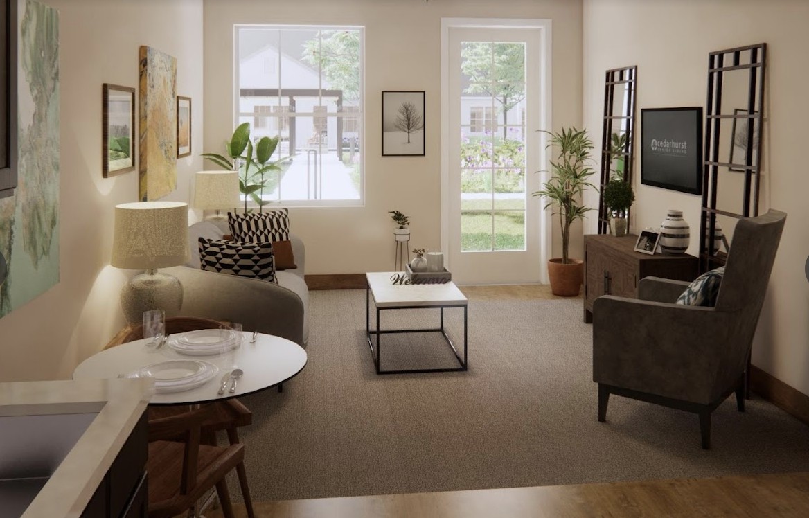 A cozy living room with modern decor, featuring a sofa, coffee table, and abundant natural light.