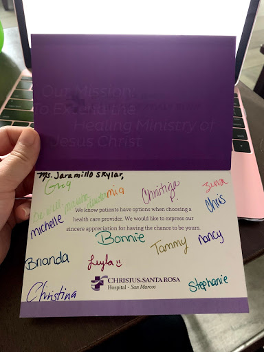 A colorful greeting card adorned with handwritten signatures from various individuals.