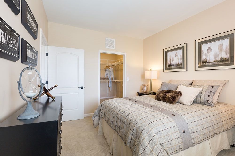 A cozy bedroom with a neatly made bed and soft lighting.