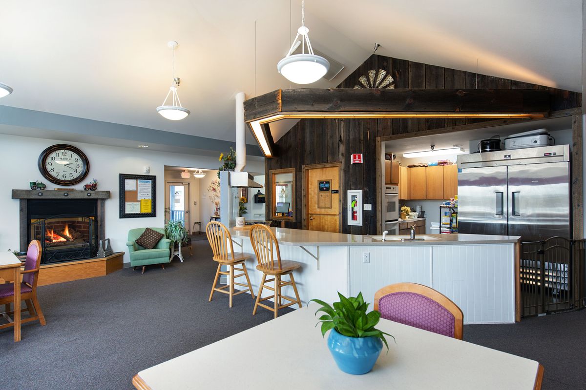 A cozy, modern kitchen and living area with seating and vibrant decor.