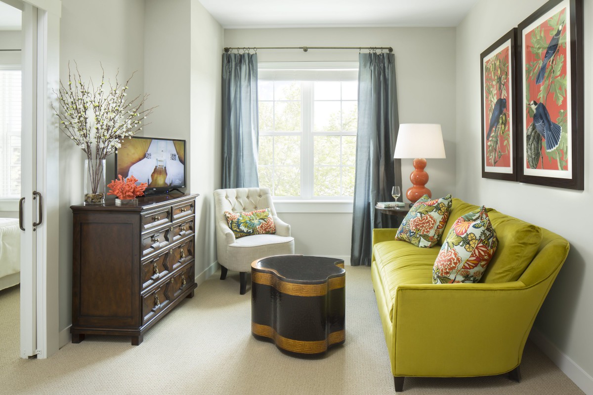 A cozy living room with a lime green sofa and stylish decor.