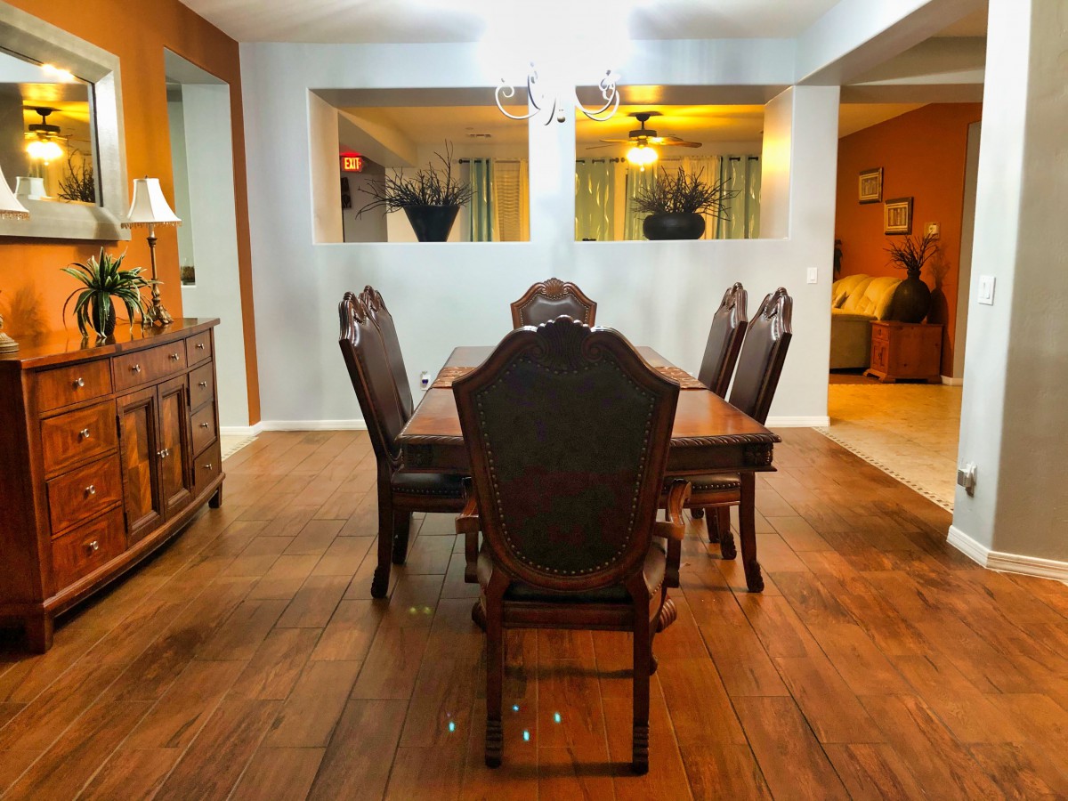 Cozy dining room with elegant wooden furniture and warm lighting.