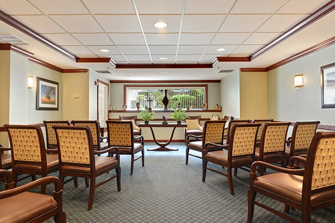 A spacious waiting room with neatly arranged chairs and a view of the reception desk.