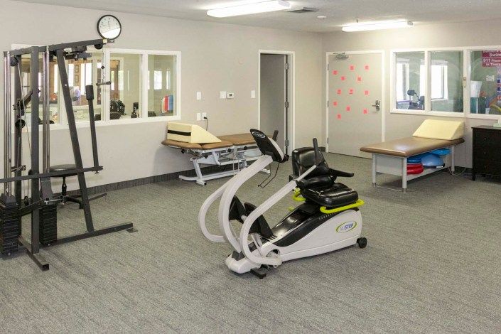 A clean and organized rehabilitation center with exercise equipment.