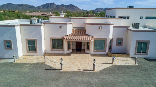 A beautiful modern house with a tiled roof and stunning mountain views.