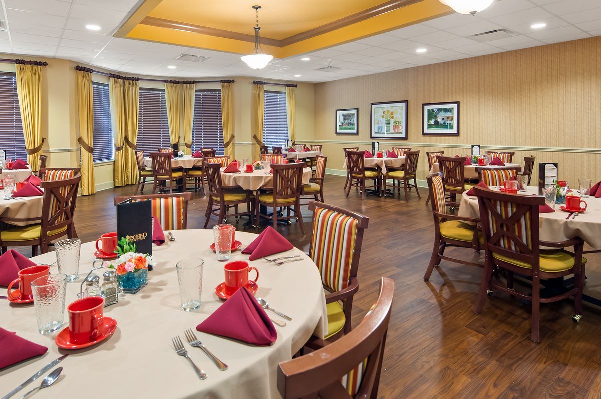 A well-decorated dining area with multiple tables set for a meal.