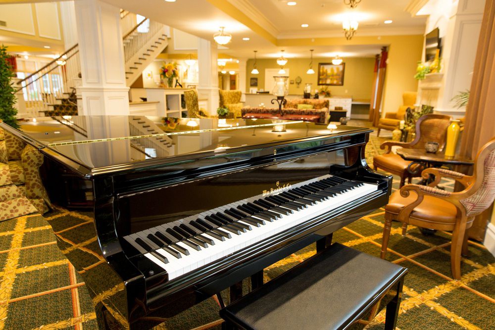 A grand piano elegantly placed in a luxurious hotel lobby.