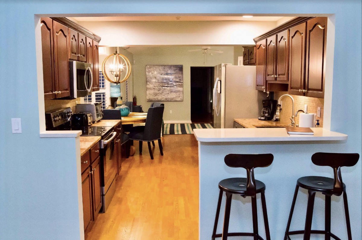 A cozy kitchen and dining area featuring wooden cabinets, a dining table, and modern appliances.