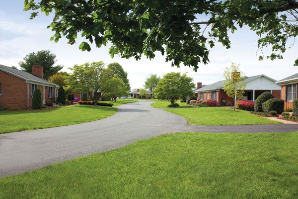 A peaceful suburban neighborhood with neatly manicured lawns and tree-lined streets.