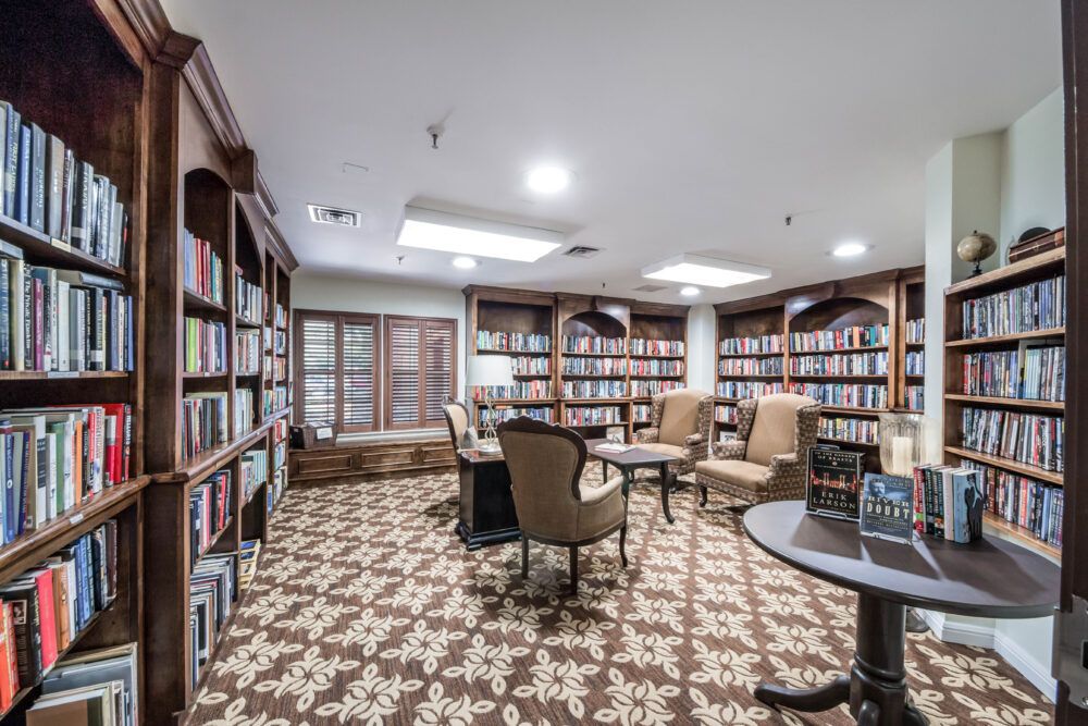 A cozy library with bookshelves and a comfortable reading area.