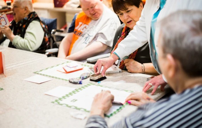 A group of people engaged in a collaborative activity around a table.