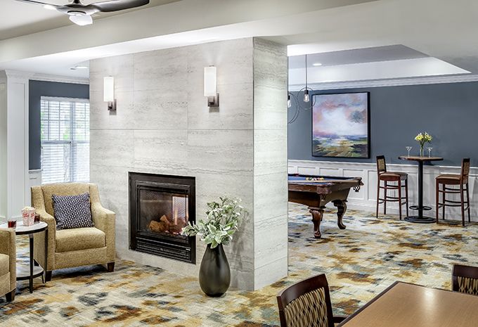 A modern living space featuring a fireplace, pool table, and contemporary decor.