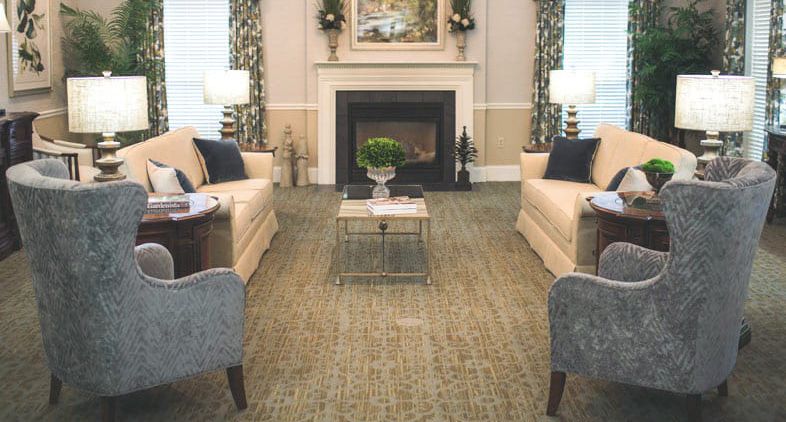 A cozy living room with a fireplace, sofas, and elegant decor.