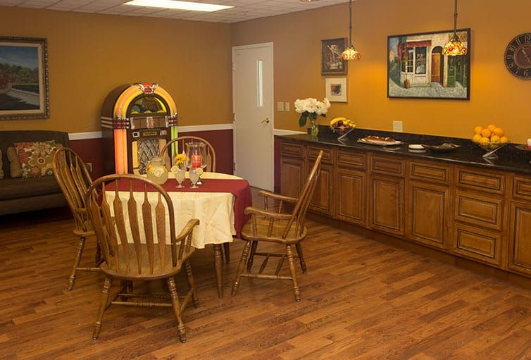 A cozy dining area with a vintage jukebox and wooden furniture.