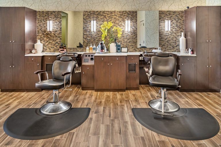 Modern hair salon interior with stylish chairs and mirrors.