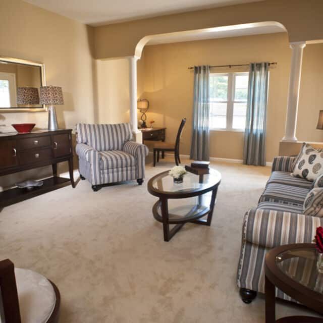 A cozy living room featuring comfortable seating and a warm atmosphere.