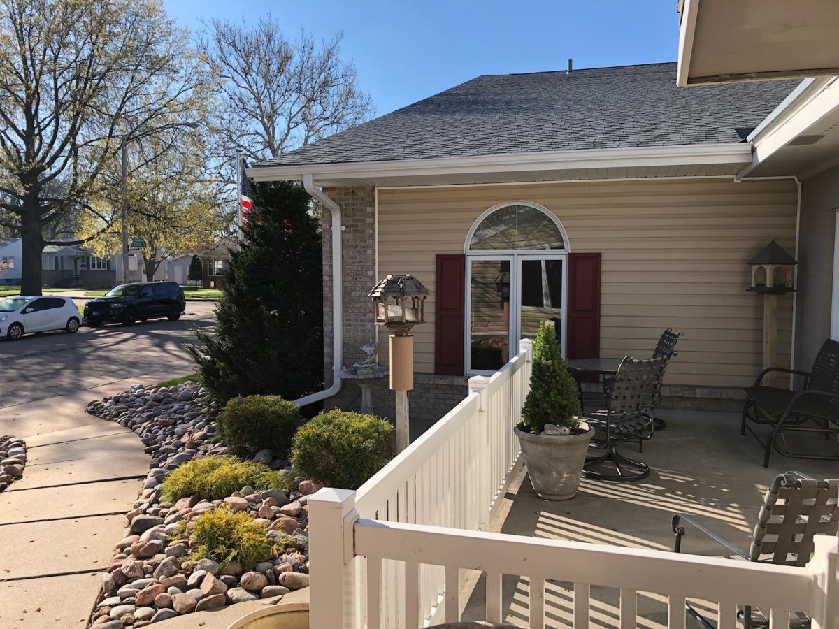 A cozy house with a well-maintained garden and a sunny patio area.