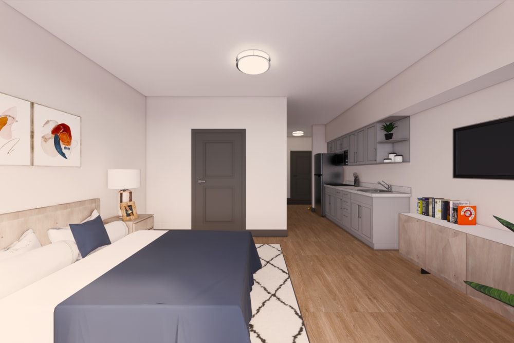A modern and minimalist bedroom with a kitchenette, featuring elegant furnishings and warm lighting.