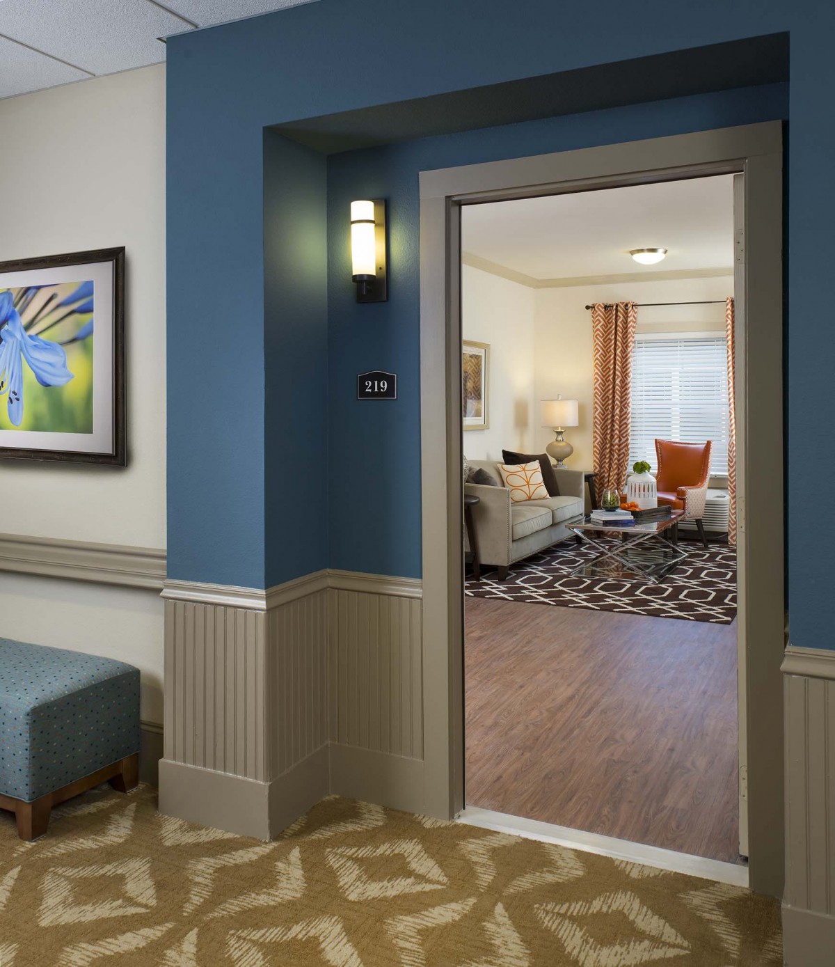 A view through a hallway into a cozy living room with elegant dcor.