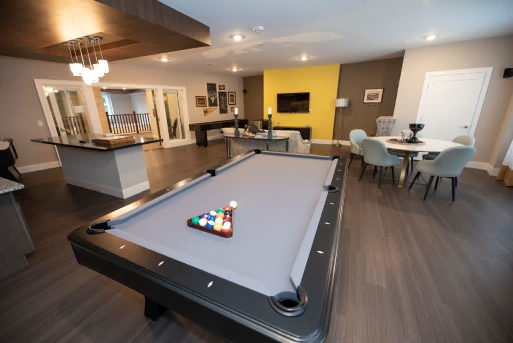 Modern entertainment room featuring a sleek pool table and stylish decor.