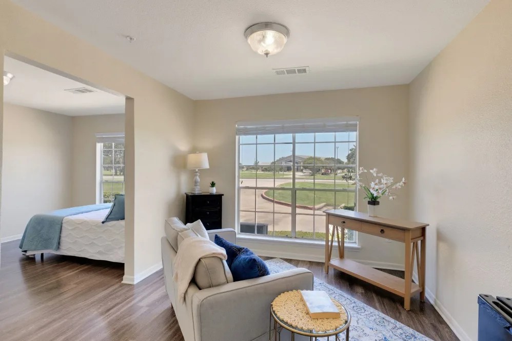 A cozy living area with a large window offering scenic views and ample natural light.