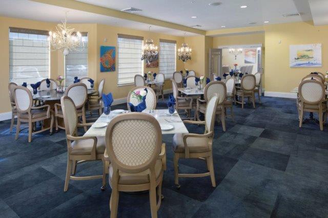 An elegant dining room with neatly set tables and classic decor.